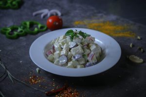Creamy potato salad with herbs and spices
