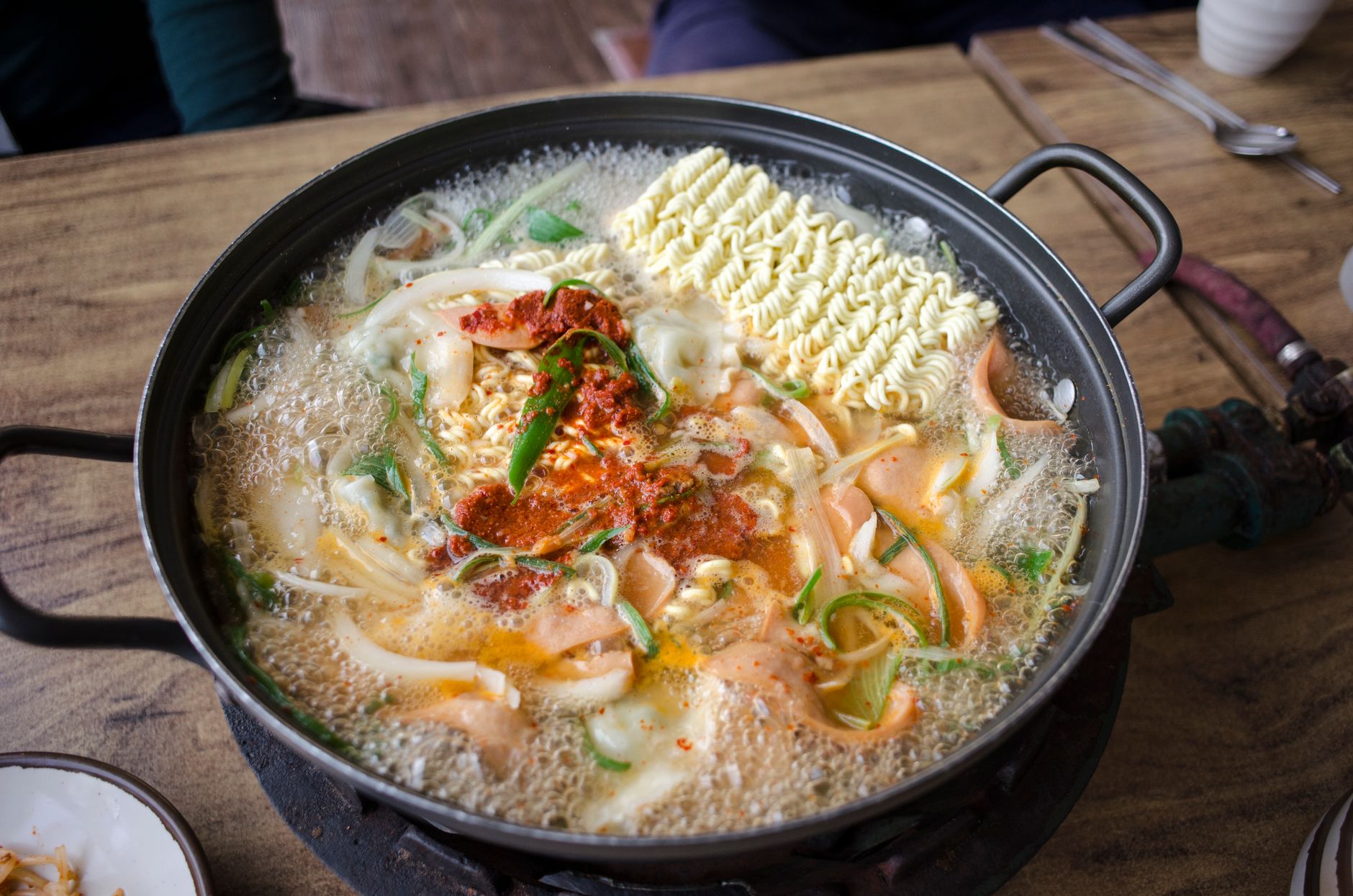 Delicious and spicy Korean ramen soup with vegetables boiling in a pan, capturing the essence of authentic Asian cuisine.