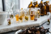 Close-up of various aromatic floral oils in glass bottles, showcasing their vibrant colors and natural ingredients.