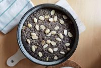 aap-gluten-free-dessert-recipes-with-almond-flour-1790857703 Top view of a homemade almond and poppy seed cake in a pan, perfect for dessert enthusiasts.