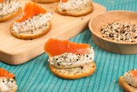 aap-smoked-cream-cheese-recipes-for-party-appetizers-1791554296 Delicious salmon and cream cheese appetizers on crackers, perfect for any occasion.