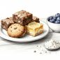 Brownies, cookies, and lemon bars sit beside blueberries and almond flour.